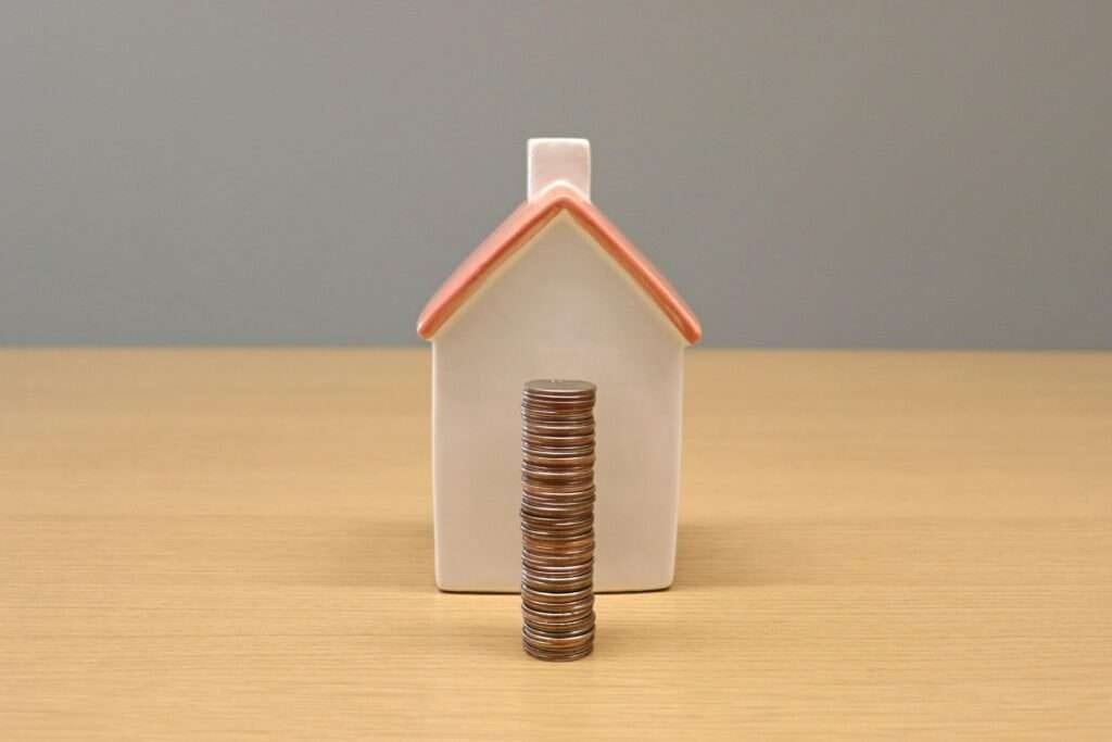 a small house with a stack of coins