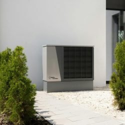 pexels-photo-20046693-20046693 Outdoor air conditioner unit on a modern building surrounded by greenery and landscaping.