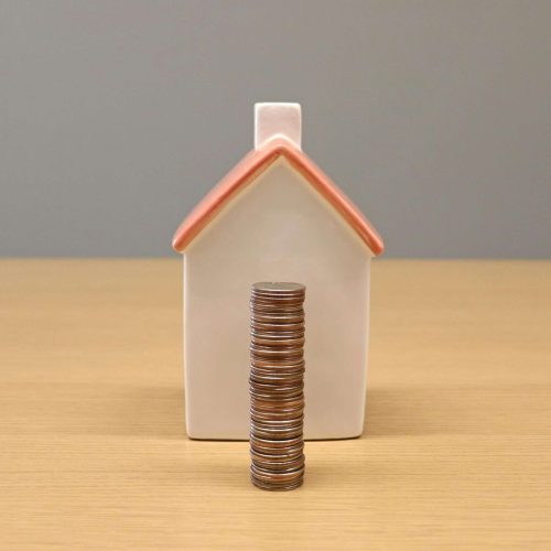 a small house with a stack of coins