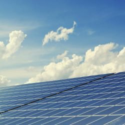 pexels-photo-356036-356036 Sleek modern solar panels under a vibrant blue sky with clouds, symbolizing clean energy.